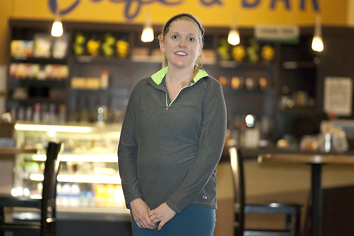 the 31-year-old Amy Buford stands in a coffee shop