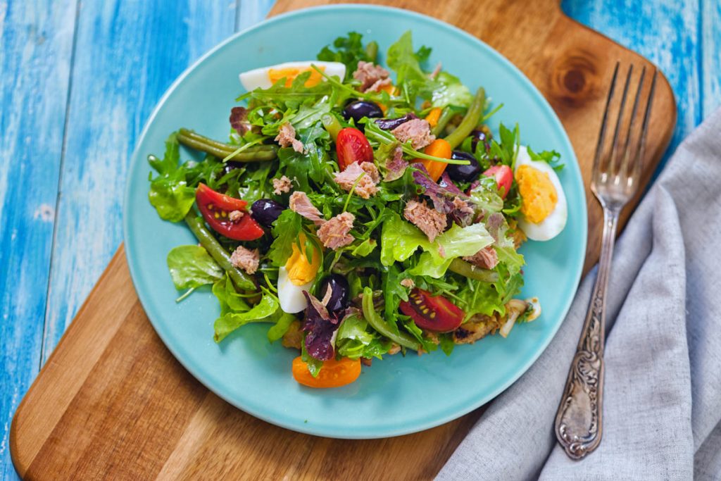 salad nicoise on a blue plate