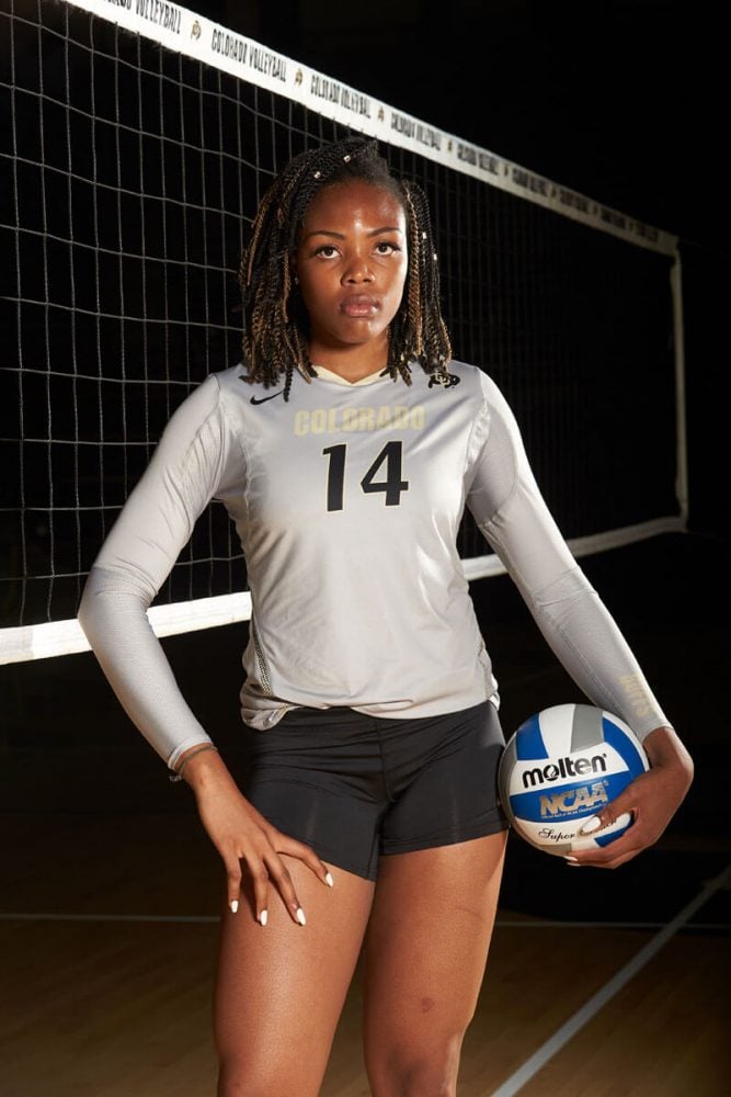 player portrait of her holding ball in front of the net
