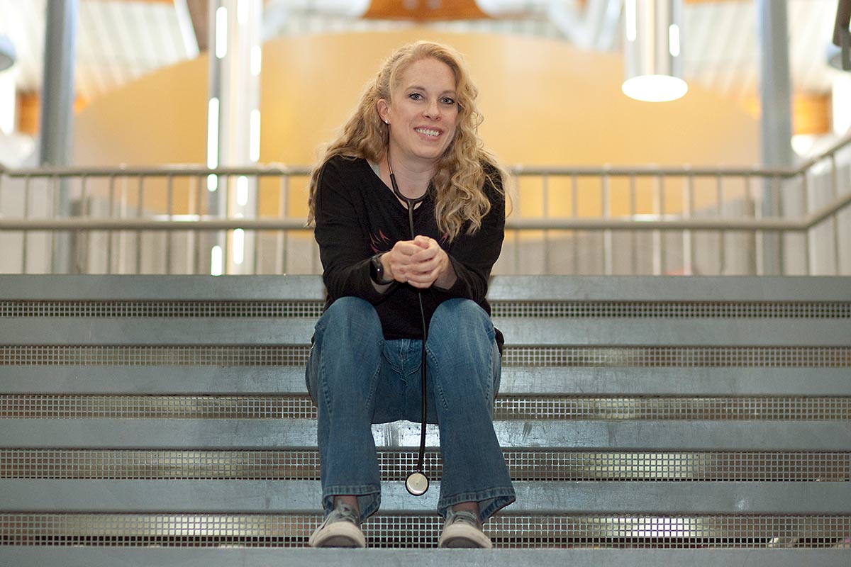 Brandi sits on the steps inside the school