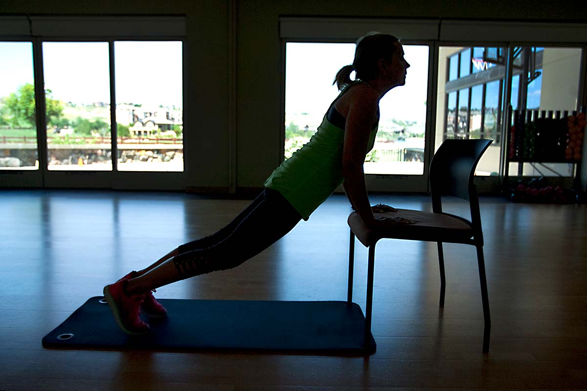 women does yoga pose on chair to help overcome cancer related fatigue