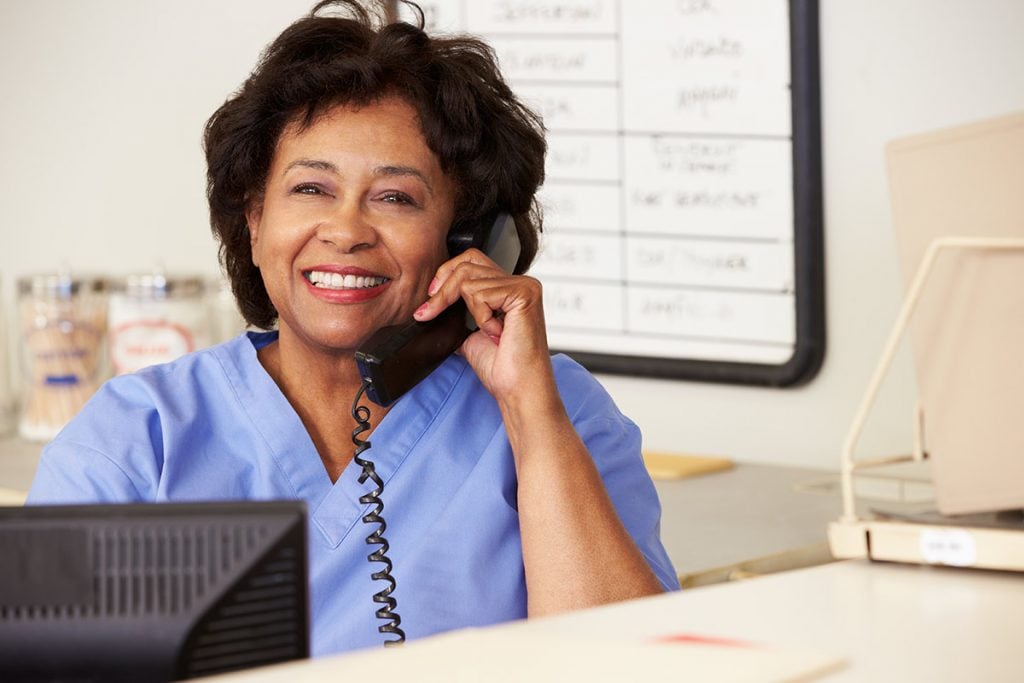 A photo of a nurse making a phone call to a patient
