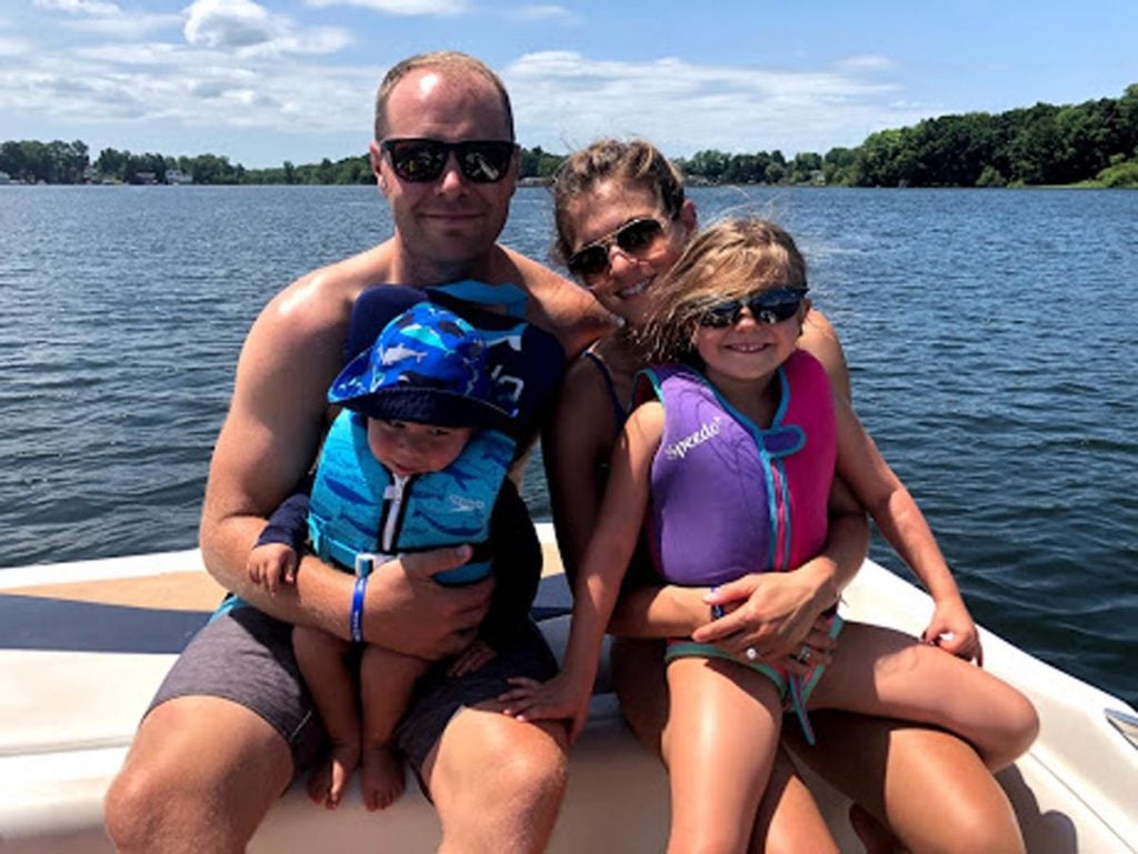 A photo of Emily Daniels, who is living with lung cancer, on a boat with her husband and children.