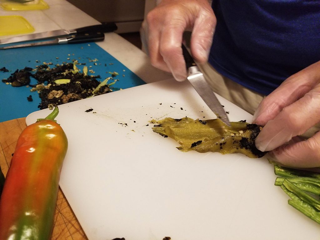 Cooking with fresh chiles. Wear gloves when scraping and cleaning chiles
