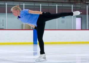 skater in mid spin on ice after recovering from talus fracture.