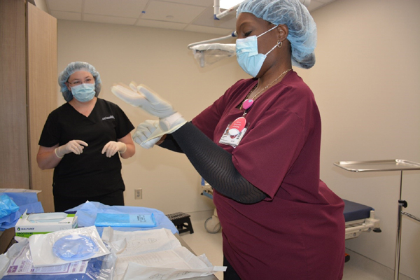 sterile refresher training with a nurse putting on gloves