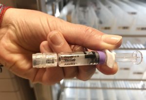 A nurse manager holds the hepatitis A vaccine.