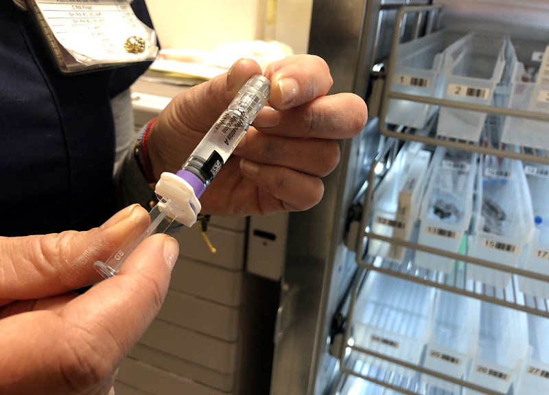 A nurse manager holds the hepatitis A vaccine