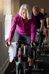 older adults on spin bikes at a gym, which should be avoided during the coronavirus outbreat.