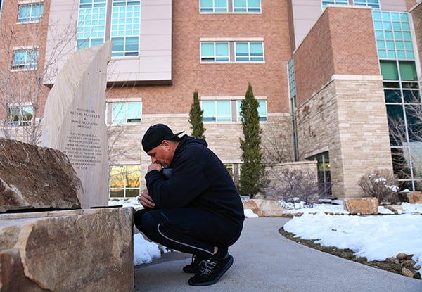 Son prays outside the hospital room of his dad, Sergio Rodriguez, a longtime JBS worker who got sick with COVID-19.