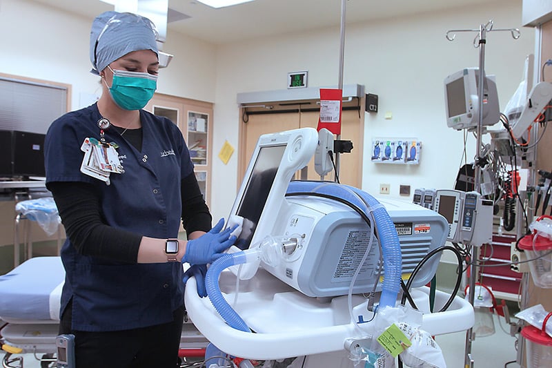 Nurse wipes down ventilator