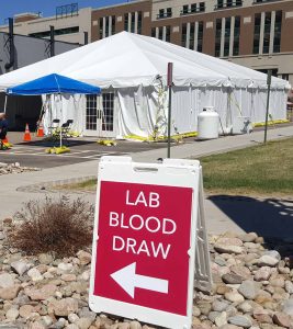A photo of a tent on the campus of UCHealth Memorial Hospital Central where new drive-thru lab services in Colorado are available.