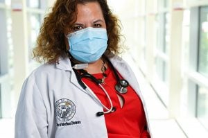 Headshot of Dr. Michelle Barron. After getting a COVID-19 vaccine, people should keep wearing masks until millions of others also get vaccines.