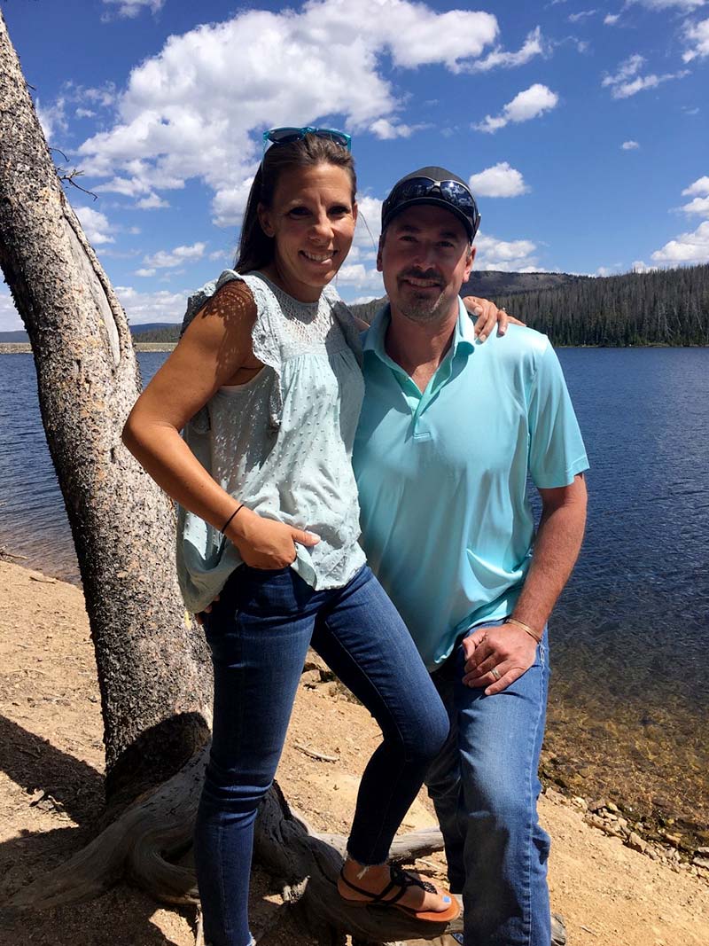 Carly and husband by a lake after she got heart failure caused by pregnancy.