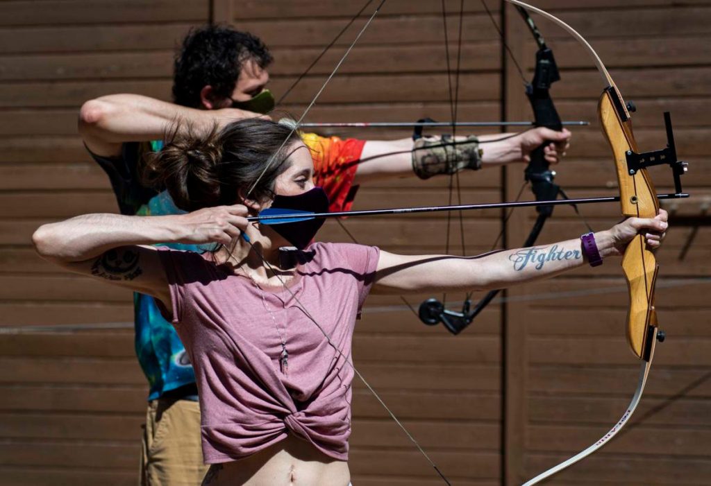 Hannah Moraski and her soon-to-be husband, Justin Smith, practice archery. Because of a new prescription drug, Givlaari, Hannah has a vast appreciation for her newfound freedom (even in a pandemic).
