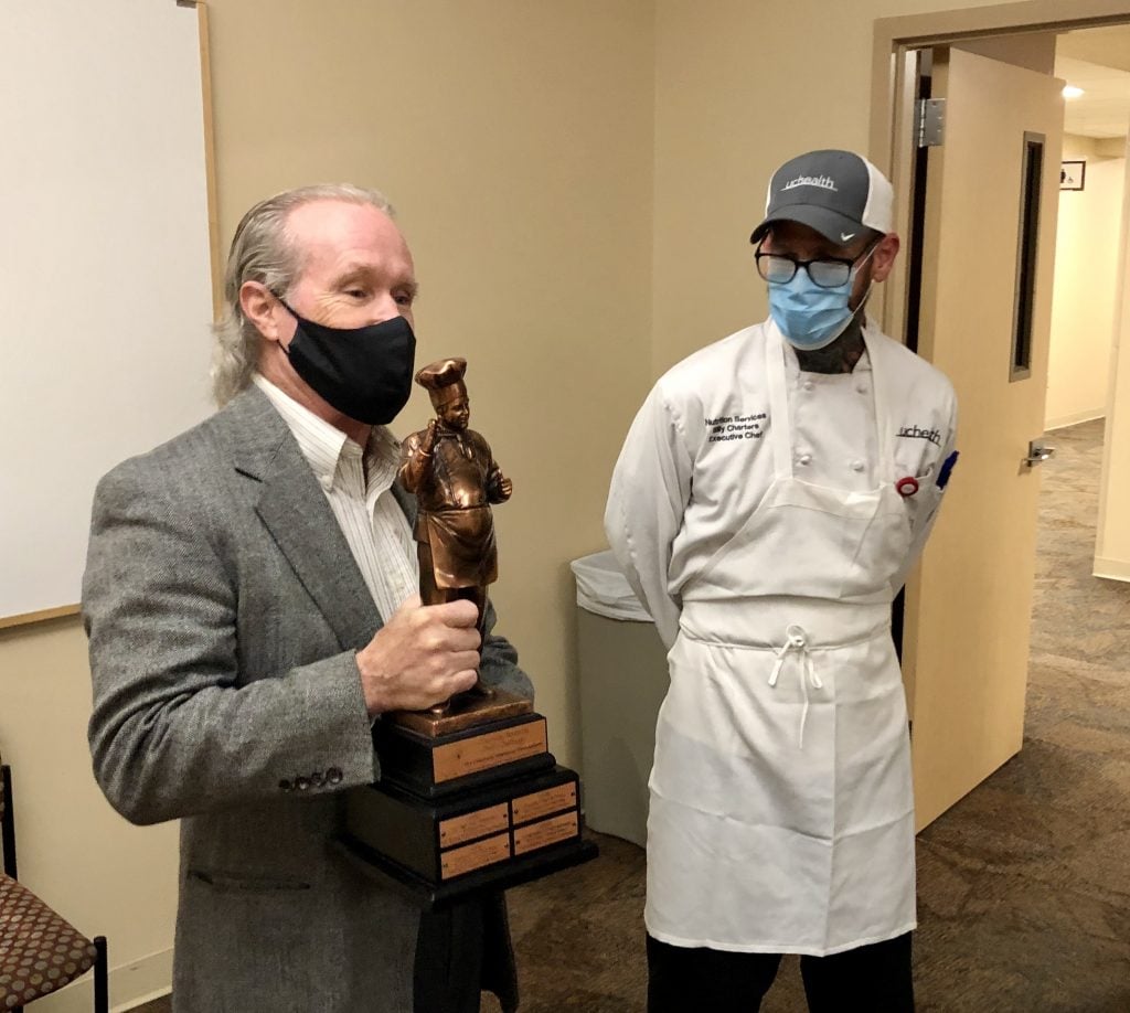 Children's Treehouse Foundation director presents trophy to Executive Chef Charters