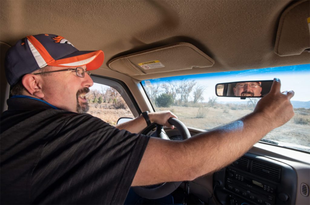 Clay Phillips behind the wheel of his truck after getting relief from epileptic seizures.