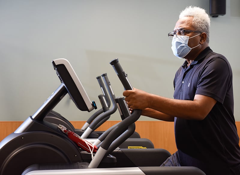 Clarence Troutman working out on a stair stepper. He's dealing with long-term symptoms of COVID-19, a group of patients who identify themselves as COVID-19 'long-haulers.'