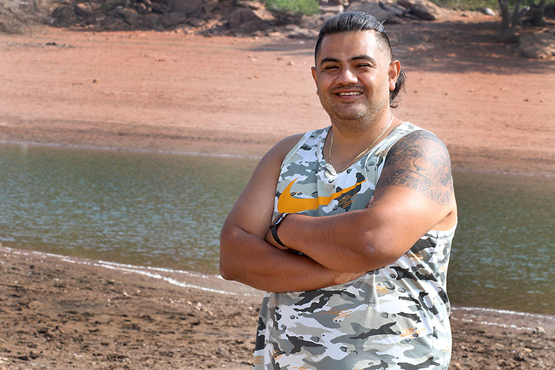 after recovering from a stroke, Edgar stands by a lake during his camping trip.