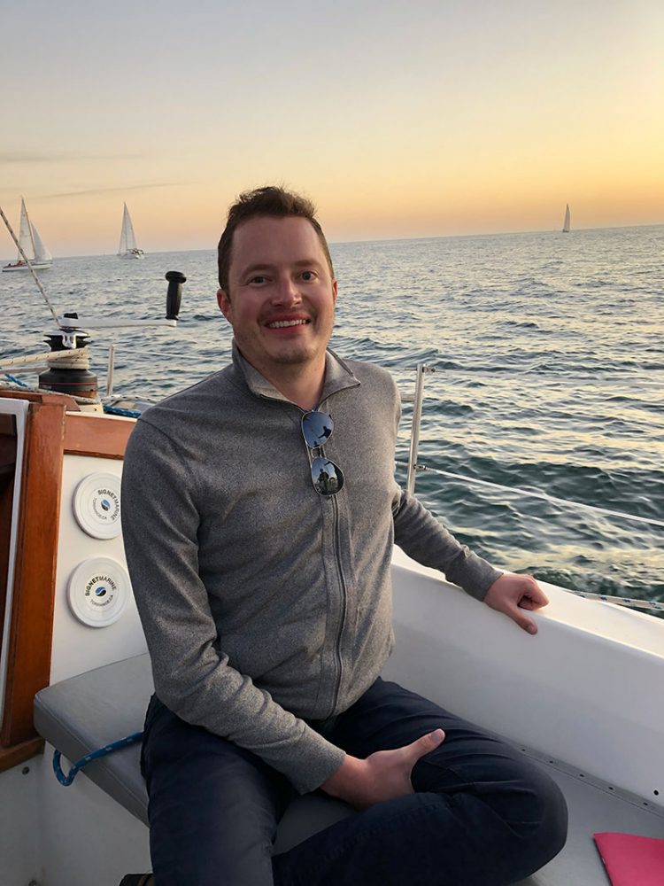 Justin, who suffers from FSHD, on a boat of the California coast.