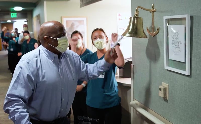 one of UCHealth's COVID survivors rings a bell as he is discharged.