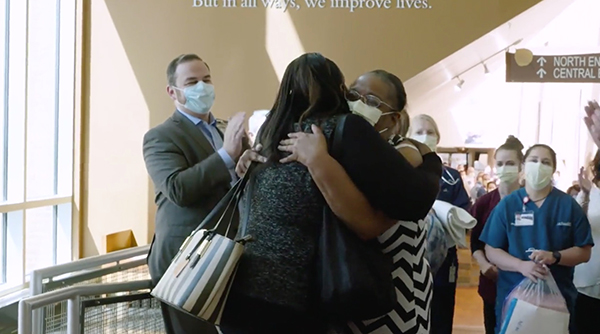 Family members celebrate a COVID survivors' release from UCHealth Memorial Hospital Central.