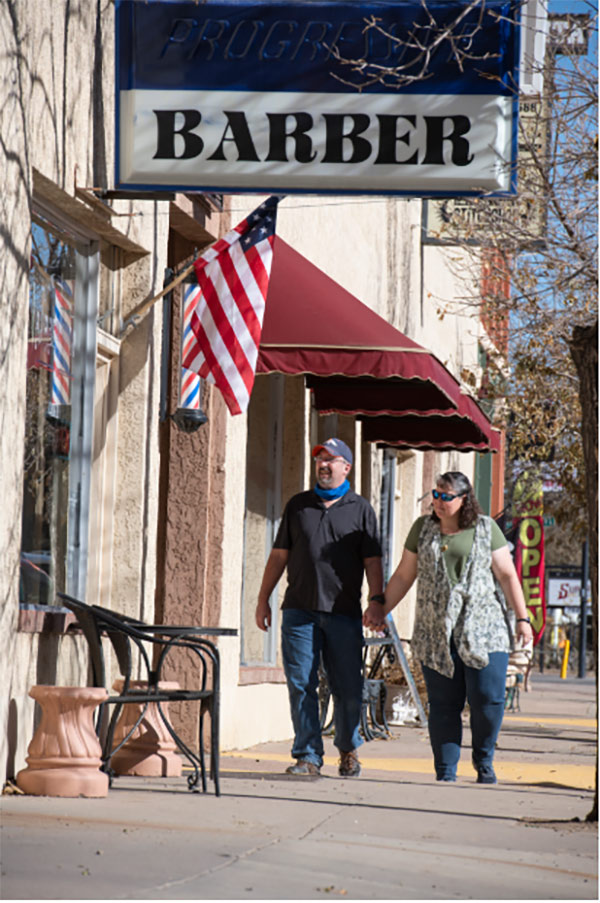 Clay Phillips and his wife, Diana, walk along Main Street in Florence, Colorado.