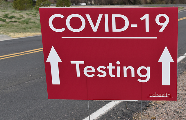 Sign points to COVID-19 testing site.