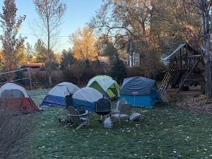 Due to the fall Colorado COVID-19 spike, Dr. Richard Zane only allowed his son to get together with friends at an ourdoor sleepover. The photo shows tents and a firepit in a backyard.
