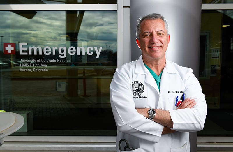 Why COVID-19 vaccines are safe. Dr. Richard Zane smiles outsie the Emergency Department at UCHealth University of Colorado Hospital