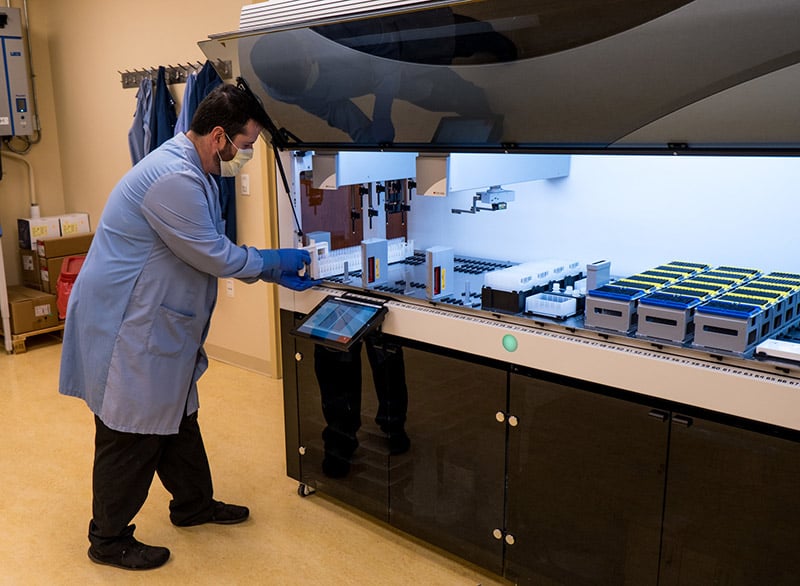 UCHealth clinical laboratory employee working with new COVID-19 testing technology