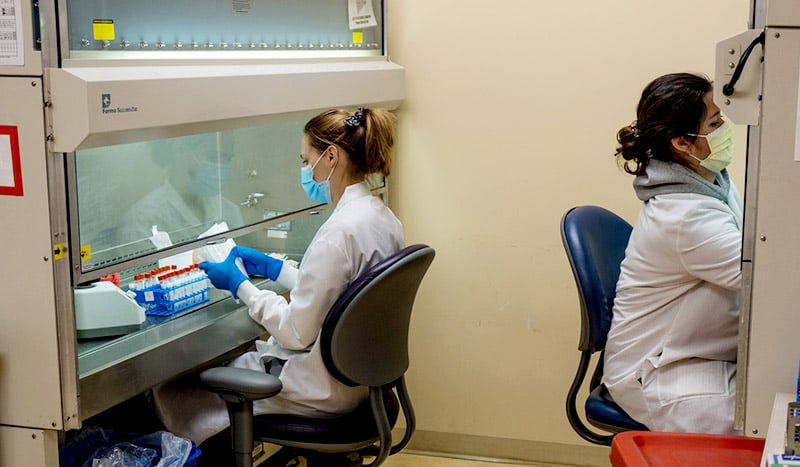 UCHealth clinical laboratory employees working with new COVID-19 testing technology