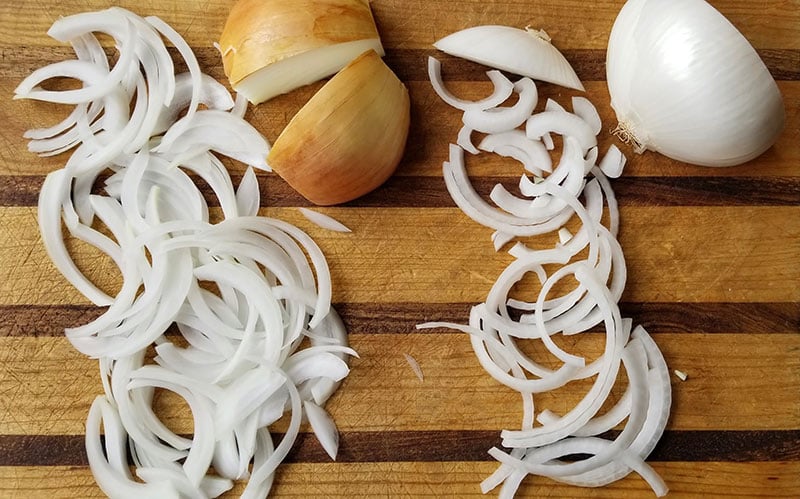 The yellow onion was cut “pole-to-pole,” while the white onion was cut along its “equator.” Note that the yellow onion’s slices are all but equal in size.