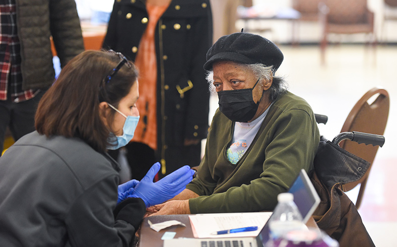 Joan Hooker, 89, received her vaccine on Sunday at her church, Shorter Community AME in Denver. Who should get booster shots now?
