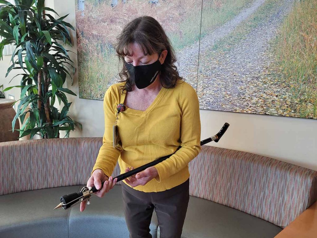 UCHealth Injury Prevention Specialist Lori Morgan demonstrates how attaching an ice tip to a cane can provide additional safety when walking in snow or ice.