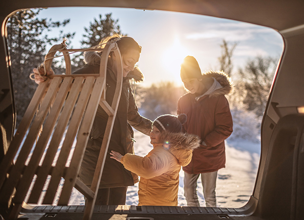 Great parks in Denver's backyard include Robinson Park, which is known for its sledding hill. Photo of family with sled. Photo: Getty Images.