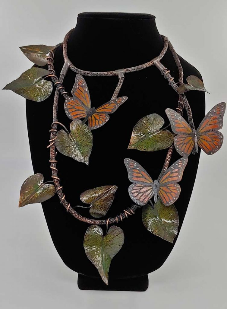 metal art piece with butterflies