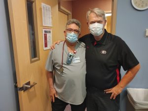 Lance James, right, poses for a picture with his former respiratory therapist Kevin Londrigan, while visiting the MCR CICU recently to say thanks to his caregivers for saving his life two years prior. Photo by Kati Blocker, UCHealth.