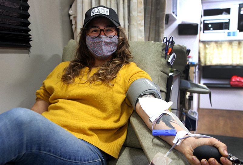 Zoe Finn donates blood recently after getting a tattoo. Photo by Kati Blocker, UCHealth.