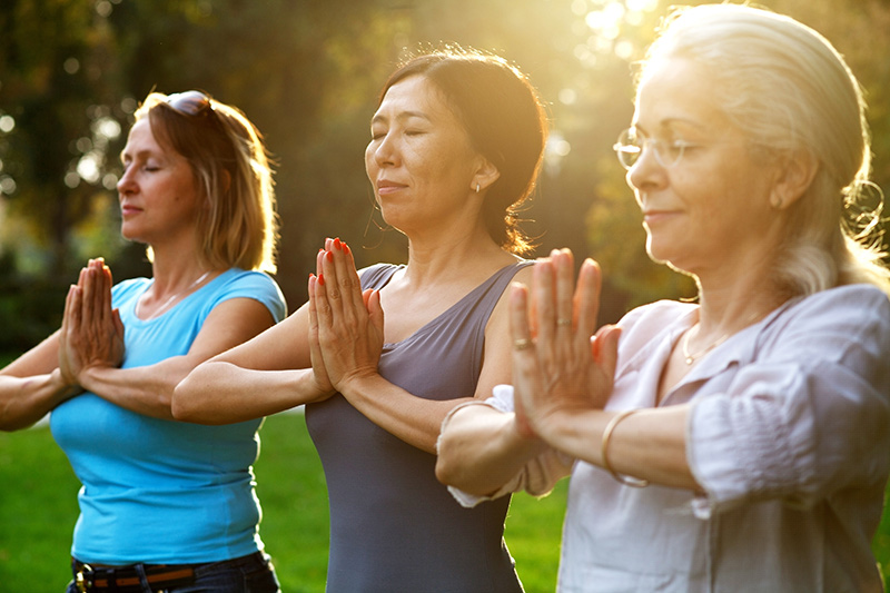 Meditation and mindfulness. Three women do yoga. Photo: iStock.