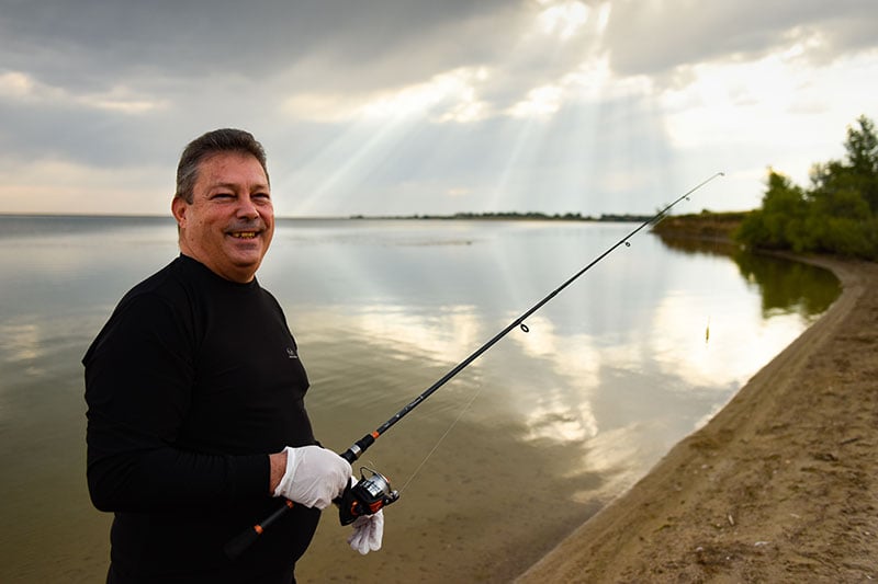 Man, who will get a third dose of COVID-19 vaccine because he had a transplant, now enjoying fishing.