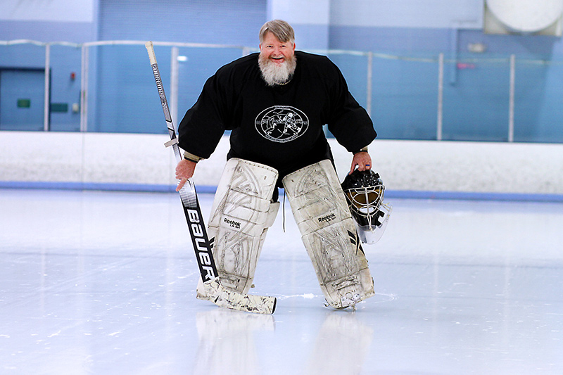 hockey player Dennis Borland in goalie pads on the ice.