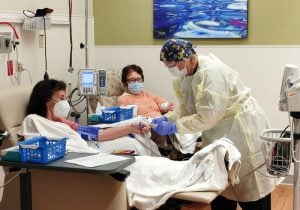 Two patients receive monoclonal antibody infusions at UCHealth Poudre Valley Hospital to help them avoid sever illness..