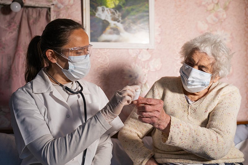 Reducing opioid use in hospitals is a great way to prevent addiction. Here a medical provider gives pills to a patient.