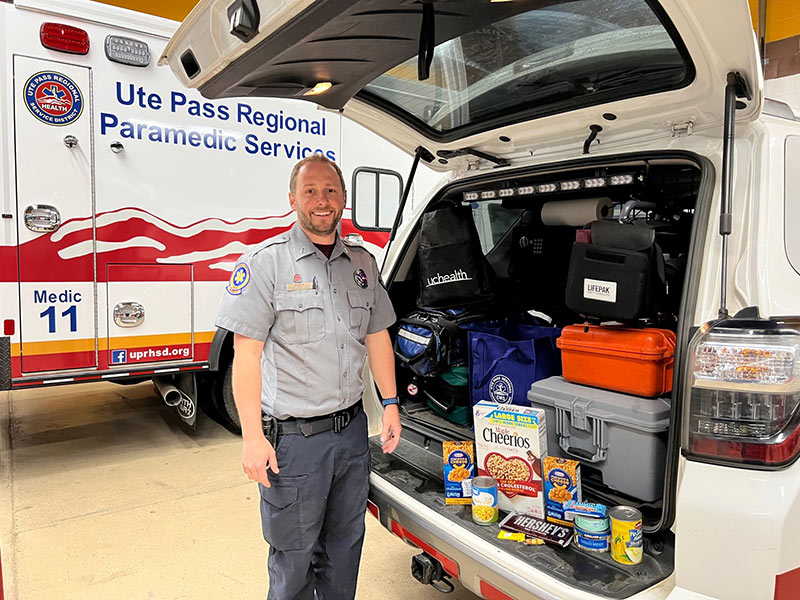 Lt. Ryan Brown, a community paramedic with Ute Pass Regional Health Services District, loads a vehicle with food to help with food insecurity in Teller and Park counties.