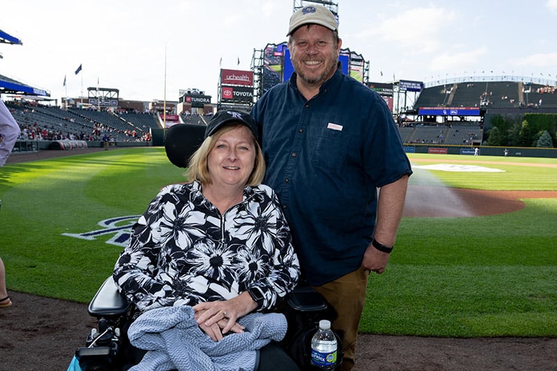ALS warrior Christine Gilmore and her husband, Chris, at Coors Field on Major League Baseball's Lou Gehrig's Day in June 2022.
