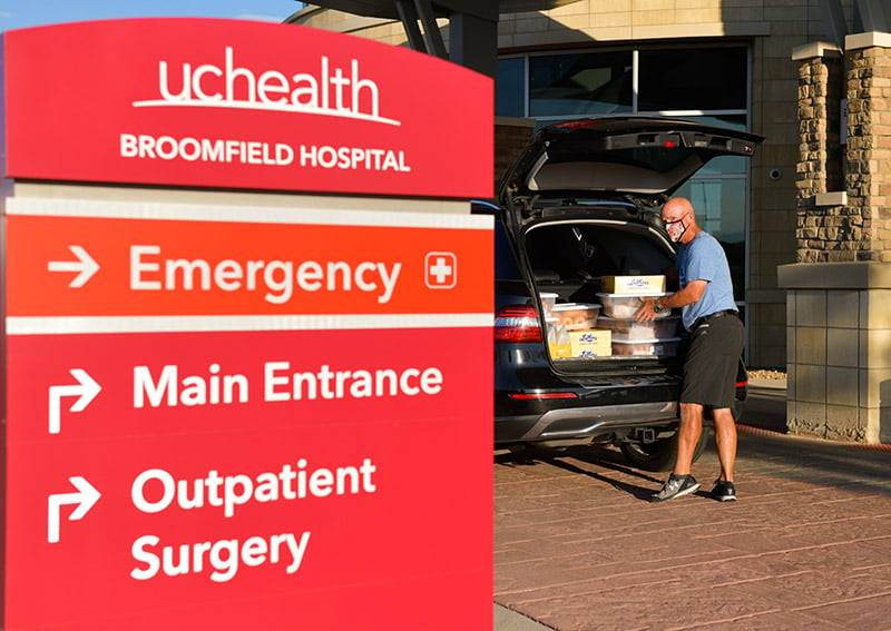 Barry Hubbard, 66, is the “donut dude” of their two-person “donut squad.” He's delivering dozens to UCHealth Broomfield Hospital.