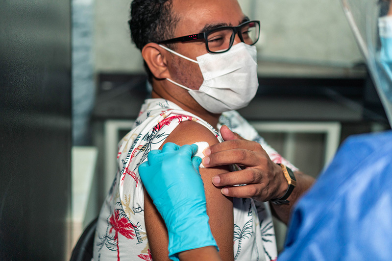 man getting the COVID vaccine as experts are watching the new covid variants.