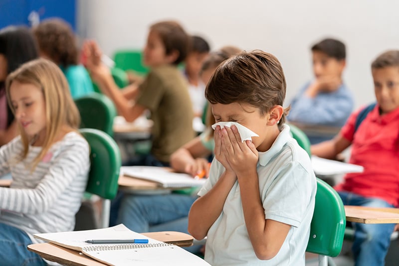 child sneezing. The flu season is here.