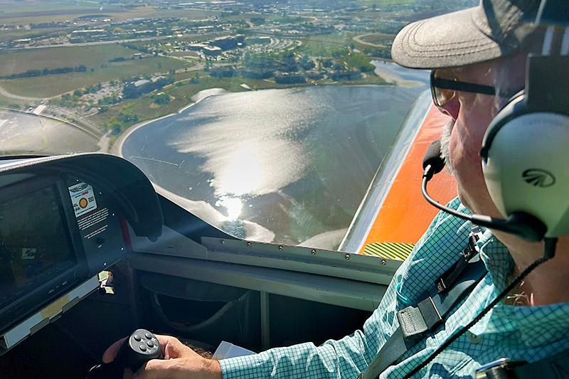 pilot flies over UCHealth Medical Center of the Rockies where he was cared for and participated in research for his tibia fracture.